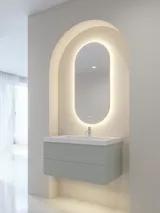 Stilfull och modern badrumsinspiration med ovala speglar med ljusreglering, stenhandfat och tvättställsskåp med fina och eleganta räfflor i en minimalistisk design, badrummet har en ljus och luftig atmosfär med elegant belysning och raffinerade detaljer