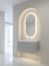 Stilfull och modern badrumsinspiration med ovala speglar med ljusreglering, stenhandfat och tvättställsskåp med fina och eleganta räfflor i en minimalistisk design, badrummet har en ljus och luftig atmosfär med elegant belysning och raffinerade detaljer