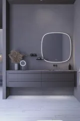 Stor badrumsinspiration med grå underskåp med integrerat handtag, snyggt sidomonterat handfat, fyrkantig spegel med rundade hörn, väggar i betonglook och råa material för en urban look