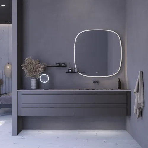 Stor badrumsinspiration med grå underskåp med integrerat handtag, snyggt sidomonterat handfat, fyrkantig spegel med rundade hörn, väggar i betonglook och råa material för en urban look