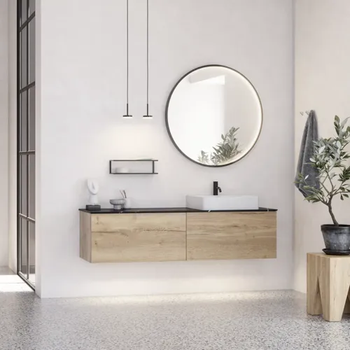 Stor urban badrumsinspiration med möbler i naturlig ek, stenbänkskiva med fyrkantig vask, runt spegel med svart kant, naturfärger och terrakottagolv ger en industriell och modern känsla