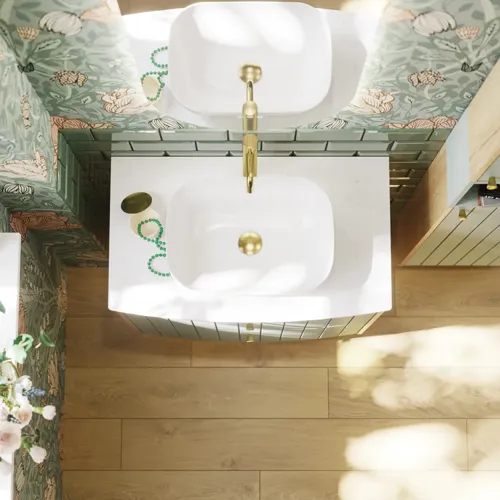Badrumsinspiration med badrumsmöbler i grön specialfärg med sidor i naturlig ek, eleganta räfflor, stilfull bänkskiva med romantiskt ovalt bordsmonterat handfat, vacker oval spegel, ger tillsammans med blommigt tapet ett graciöst, vintage retro utseende.