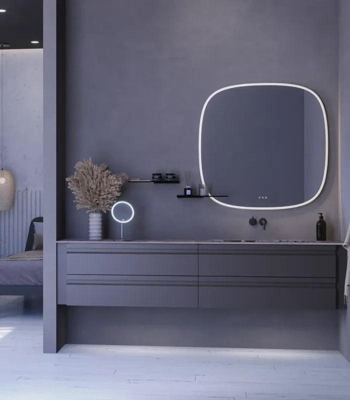 Stor badrumsinspiration med grå underskåp med integrerat handtag, snyggt sidomonterat handfat, fyrkantig spegel med rundade hörn, väggar i betonglook och råa material för en urban look